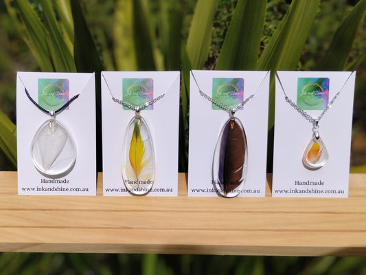 resin pendant necklaces made with real feathers inside